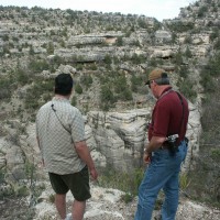 Dan Lorraine and Rick Lynch view cliff dwellings within Walnut Canyon